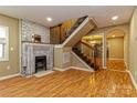 Inviting living room with a brick fireplace, wood floors, and an open staircase at 209 W Marsh St, Salisbury, NC 28144