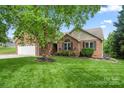 Charming brick home with a well-manicured lawn, two-car garage, and inviting front entrance at 2315 Perry Rd, Denver, NC 28037