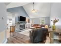 Cozy living room with stone fireplace, vaulted ceilings, wood floors, and comfortable seating at 2315 Perry Rd, Denver, NC 28037