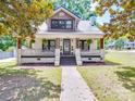 Charming two-story home features a welcoming front porch with dark trim and a walkway to the door at 232 W Wilson Ave, Mooresville, NC 28115