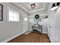 Inviting entryway with stylish decor, wood floors, paneled accent wall, and decorative lighting at 2853 Mathis Church Rd, Catawba, NC 28609