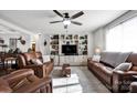 Spacious living room featuring built-in shelving, ceiling fan, and comfortable leather seating at 2853 Mathis Church Rd, Catawba, NC 28609