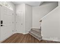 Inviting foyer with wood-look floors, a carpeted staircase, and a neutral color palette at 3021 Misty Harbor Cir, Cramerton, NC 28032