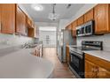Well-equipped kitchen with stainless steel appliances, wood cabinets, and a functional layout at 3021 Misty Harbor Cir, Cramerton, NC 28032
