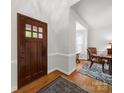 Foyer featuring hardwood floors, decorative rug, and a view into the dining area at 3133 English Sparrow Ln, Charlotte, NC 28210