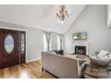 Bright living room with hardwood floors, vaulted ceiling, and elegant chandelier at 3223 Rheinwood Ct, Matthews, NC 28105