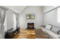 Inviting living room showcasing a fireplace, hardwood floors, and modern decor at 3223 Rheinwood Ct, Matthews, NC 28105