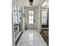 Bright foyer featuring elegant tile flooring, a decorative wreath on the front door, and white trim at 397 Luray Way, Rock Hill, SC 29730