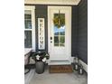 A charming front door features a decorative wreath, a welcome sign, and stylish lanterns at 397 Luray Way, Rock Hill, SC 29730