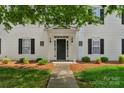 Charming building entrance featuring a covered porch and well-maintained landscaping at 4072 Town Center Rd, Harrisburg, NC 28075