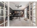 Cozy office with a ceiling fan, custom shelving and ample workspace, featuring a dog bed at 4117 Wallbrook Dr, Matthews, NC 28105