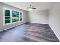 Spacious living room featuring hardwood floors, large windows, and modern ceiling fan at 412 Brook St, Salisbury, NC 28146