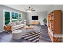 Bright, staged living room with large window, ceiling fan, modern furniture, and stylish decor at 412 Brook St, Salisbury, NC 28146