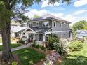A beautiful two-story home with mature trees, lovely landscaping, and a classic design at 421 Mcdonald Ave, Charlotte, NC 28203
