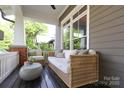 Comfortable front porch area with cushioned seating, a small table, and a relaxing atmosphere at 421 Mcdonald Ave, Charlotte, NC 28203