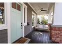 Inviting front porch featuring a porch swing, ceiling fan, and stylish accents at 421 Mcdonald Ave, Charlotte, NC 28203