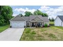 Inviting one-story home with a well-manicured lawn, covered porch, and an attached two-car garage at 4949 Southview Dr, Hickory, NC 28602