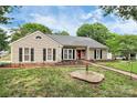 Well-maintained home with neat landscaping, a red brick walkway, and a cozy front porch at 5601 Carmel Station Ave, Charlotte, NC 28226
