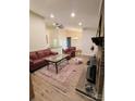 Cozy living room with fireplace, ceiling fan, and wood-look flooring at 5601 Carmel Station Ave, Charlotte, NC 28226