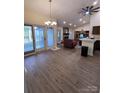 Open living space with sliding doors, wood-look flooring, and a modern ceiling fan at 5601 Carmel Station Ave, Charlotte, NC 28226