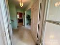 Bright entryway featuring neutral walls, tiled floors, and a clear view into the living spaces at 5938 Sharon Rd, Charlotte, NC 28210