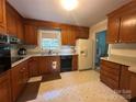 Traditional kitchen with wooden cabinets, and appliances, offering functionality and a classic style at 5938 Sharon Rd, Charlotte, NC 28210