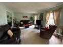Spacious living room with multiple seating areas, plush carpet, and ample natural light at 5938 Sharon Rd, Charlotte, NC 28210