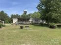 Ranch-style home with a ramp leading to a covered back deck and a spacious yard at 7494 Flat Creek Rd, Lancaster, SC 29720