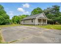 A quaint home with a spacious driveway surrounded by lush greenery at 842 Murphy St, Kannapolis, NC 28081