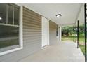 Covered porch with concrete floor and fresh, bright trim at 842 Murphy St, Kannapolis, NC 28081