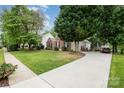 Well-maintained home on lush lot with long driveway leading to garage and backyard deck at 10011 Spring Park Dr, Charlotte, NC 28269