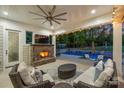 Enjoy this outdoor space with a cozy fireplace and a view of the beautiful pool area at 106 Thunder Hill Rd, Mooresville, NC 28117