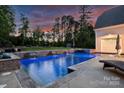 The backyard boasts a stunning in-ground pool with stone accents and relaxing water features at 106 Thunder Hill Rd, Mooresville, NC 28117