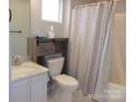 Cozy bathroom with a vanity, toilet, and shower/tub combo with modern fixtures at 109 Gatwick Ct, Statesville, NC 28677