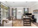 Bright home office with neutral tones, patterned curtains, and ample natural light at 1098 Matchstick Sw Pl, Concord, NC 28025