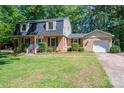 Lovely brick home with a black roof, garage, and tidy, green lawn at 1324 Princeton Ave, Gastonia, NC 28054