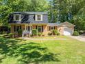 Traditional brick home with a well-kept lawn, garage, and lush greenery at 1324 Princeton Ave, Gastonia, NC 28054