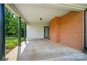 Covered carport area attached to brick home featuring ample parking space and backyard access at 137 Burton Hills Cir, Gastonia, NC 28054