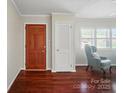 Inviting entryway featuring hardwood floors, coat closet, and living room access at 137 Burton Hills Cir, Gastonia, NC 28054