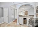 Open concept kitchen with granite countertops, stainless appliances, and adjacent wine cooler at 13932 Queens Harbor Rd, Charlotte, NC 28278