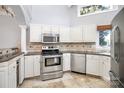 Updated kitchen with stainless steel appliances, granite counters, and designer backsplash at 13932 Queens Harbor Rd, Charlotte, NC 28278