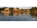 Picturesque waterfront view of condos and boat docks reflecting in the lake's sunset hues at 13932 Queens Harbor Rd, Charlotte, NC 28278