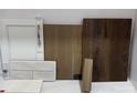Selection of interior design materials including white cabinetry, neutral tile, and light and dark tone wood samples at 153 Glenn Dr, Mooresville, NC 28115