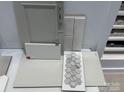 Selection of interior design materials including grey cabinetry, neutral tile and floor samples at 153 Glenn Dr, Mooresville, NC 28115