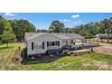 Attractive one-story home with grey siding, black shutters, a welcoming porch, and convenient carport at 159 Old Home Pl, China Grove, NC 28023