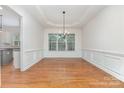 Bright dining room with hardwood floors, wainscoting, and large window at 1654 Scotch Pine Ln, Fort Mill, SC 29708