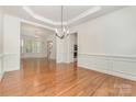 Spacious dining room with hardwood floors, wainscoting, and modern chandelier at 1654 Scotch Pine Ln, Fort Mill, SC 29708