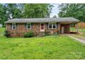 An inviting kitchen featuring white cabinets and stainless appliances at 205 Pinehurst Dr, Kings Mountain, NC 28086