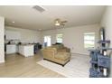 Bright living room with modern fan, neutral walls, couch, and vinyl floors at 2210 Transatlantic Ave, Charlotte, NC 28215