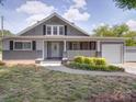 Charming gray home with a cozy front porch and well-manicured landscaping at 225 N Main St, Mount Pleasant, NC 28124